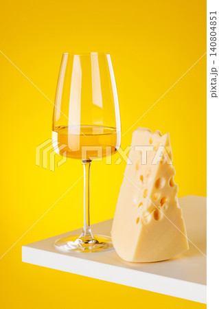 Glass of white wine with cheese on yellow background food pairing concept Glass of white wine with cheese on yellow background food pairing concept 140804851
