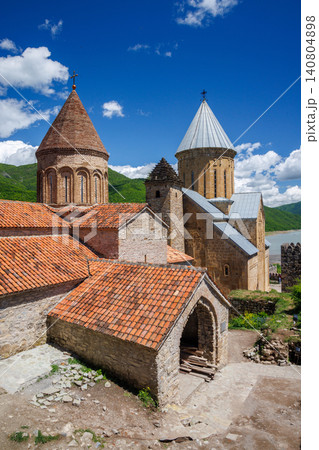 Old stone church with towers and tiled roof Old stone church with towers and tiled roof 140804898