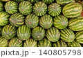 Fresh striped watermelons displayed in busy fruit market 140805798
