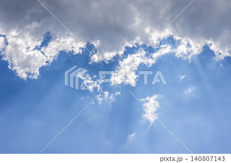 Sunbeams breaking through clouds in blue sky Sunbeams breaking through clouds in blue sky 140807143