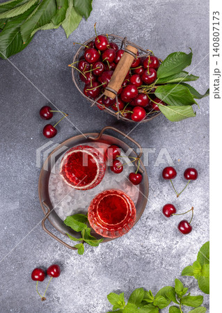 Fresh cherries and detox juice with mint on tray Fresh cherries and detox juice with mint on tray 140807173