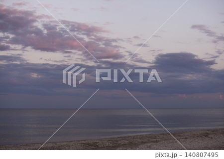 Tranquil beach and ocean under colorful evening sky, Tranquil beach and ocean under colorful evening sky, 140807495