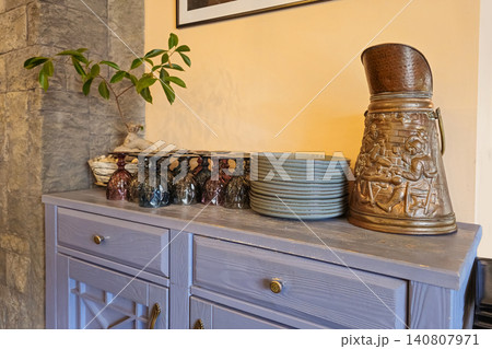 Cozy kitchen shelf holds decorative ceramic items Cozy kitchen shelf holds decorative ceramic items 140807971
