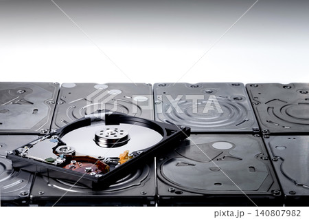 a shot of one hard drive that remove cover out to show magnetic disc inside and put it on many hdd 140807982