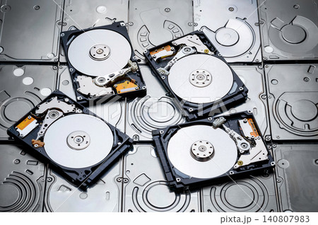 a shot of many hard drive with cover removed to show magnetic disc inside a shot of many hard drive with cover removed to show magnetic disc inside 140807983