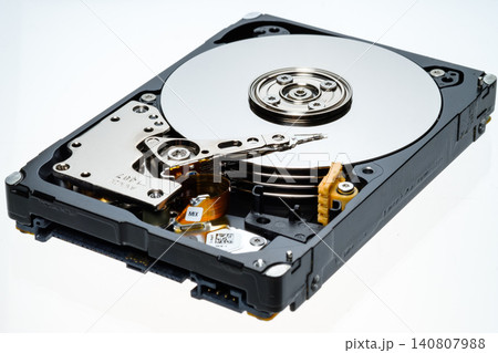 a computer's hard disk HDD data storage drive without a shield isolated in a white background shows magnetic disc and electronic parts inside a computer's hard disk HDD data storage drive without a shield isolated in a white background shows magnetic disc and electronic parts inside 140807988
