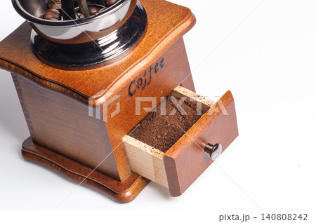 grounded coffee from the grinding machine with some coffee beans before grinded grounded coffee from the grinding machine with some coffee beans before grinded 140808242