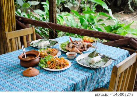 Thai-style lunch set for two people in resort somewhere Thai-style lunch set for two people in resort somewhere 140808278