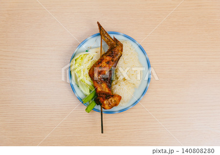 isolate dish of grilled chicken thigh and drumstick on wood table isolate dish of grilled chicken thigh and drumstick on wood table 140808280