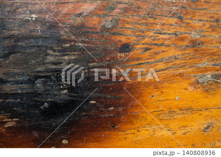 Brown wooden background with the scratch and black burning part Brown wooden background with the scratch and black burning part 140808936