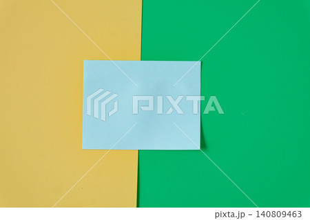 A blue sticky note on color background. 140809463