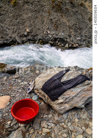 Outdoor survival laundry on mountain river near boulder Outdoor survival laundry on mountain river near boulder 140809684