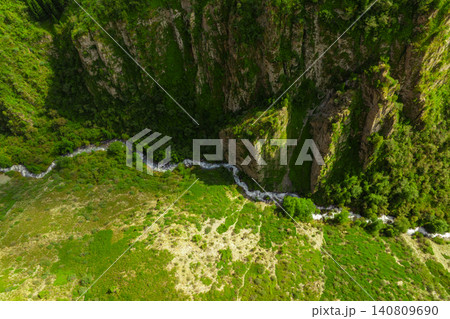 Aerial View of a River Winding Through a Green Gorge Aerial View of a River Winding Through a Green Gorge 140809690
