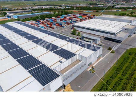 Aerial top view of a green logistics hub with solar panels and shipping containers Aerial top view of a green logistics hub with solar panels and shipping containers 140809929