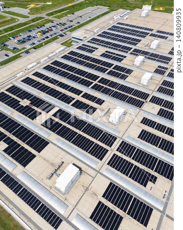 Aerial view of a modern factory with solar panels and energy storages on the roof. 140809935