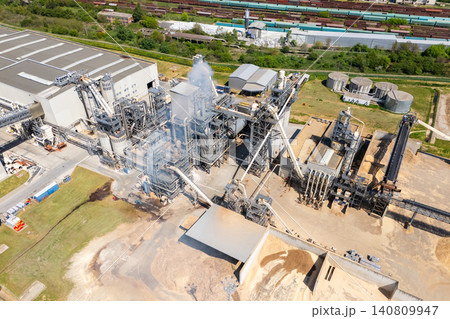 Aerial shot of a manufacturing facility with smoking chimney during production. Aerial shot of a manufacturing facility with smoking chimney during production. 140809947