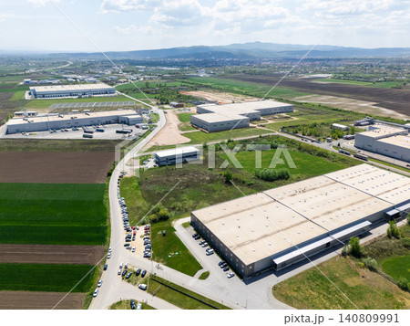 Aerial view of a massive industrial zone with manufacturing plants and warehouses. Aerial view of a massive industrial zone with manufacturing plants and warehouses. 140809991
