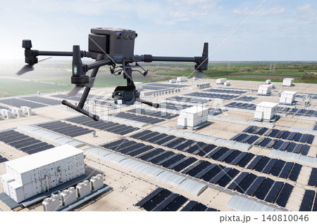Industrial drone inspecting solar panel array on a building rooftop 140810046
