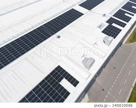 Aerial view of a modern factory with solar panels and energy storages on the roof. Aerial view of a modern factory with solar panels and energy storages on the roof. 140810086