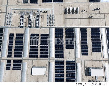Aerial view of a modern factory with solar panels and energy storages on the roof. 140810096