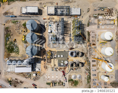 Construction site of a modern agricultural complex with silos, grain elevator and storage terminal. Aerial view. 140810121