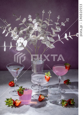 Elegant pink cocktails and strawberries with crystal glasses and white eucalyptus branches Elegant pink cocktails and strawberries with crystal glasses and white eucalyptus branches 140810553