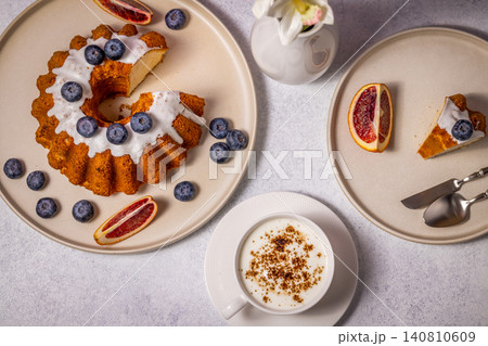 Delicious gugelhupf cake with blueberries, blood orange, and cappuccino for perfect breakfast Delicious gugelhupf cake with blueberries, blood orange, and cappuccino for perfect breakfast 140810609