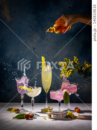 Bartender pouring syrup into cocktails with splashing liquid and mimosa flowers Bartender pouring syrup into cocktails with splashing liquid and mimosa flowers 140810616
