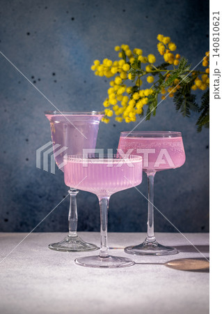 Pink cocktails with mimosa flowers on a table 140810621