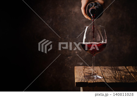 Pouring red wine into the glass 140811028