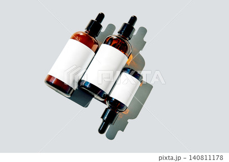 Skincare product bottles with blank labels on gray background 140811178