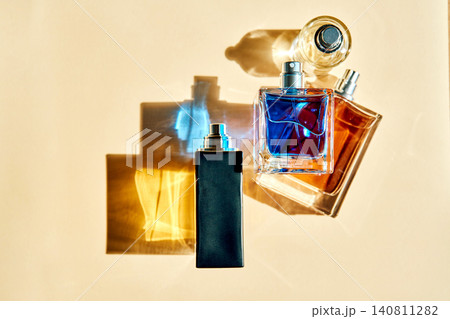 Three perfume bottles casting colorful shadows Three perfume bottles casting colorful shadows 140811282