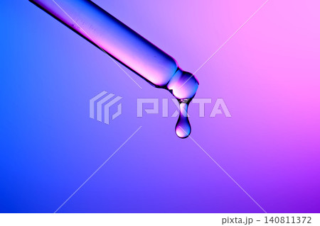 Premium serum droplet falling from pipette for healthy skin 140811372