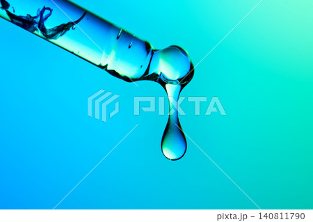 Regenerative beauty serum dripping from a pipette Regenerative beauty serum dripping from a pipette 140811790