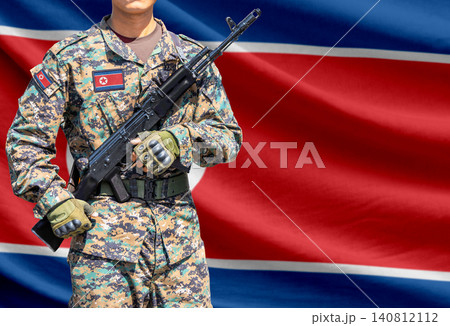 North Korea flag with soldier holding assault rifle North Korea flag with soldier holding assault rifle 140812112