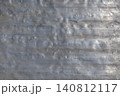 Weathered aluminum surface texture in industrial outdoor setting 140812117