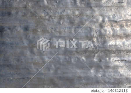 Weathered aluminum surface with dents and scratches outdoors Weathered aluminum surface with dents and scratches outdoors 140812118