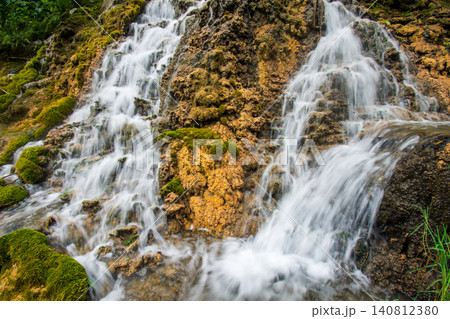 Beautiful silk effect waterfall flowing down mossy rock cliffs at Goa Tetes Lumajang Indonesia Beautiful silk effect waterfall flowing down mossy rock cliffs at Goa Tetes Lumajang Indonesia 140812380