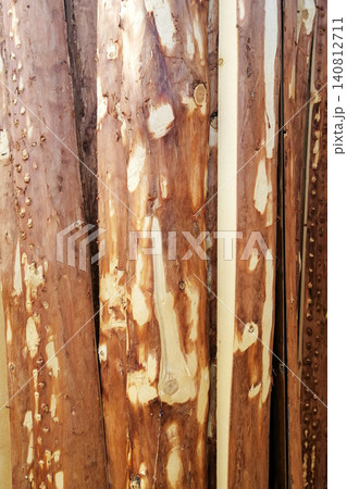 vertical wooden boards with bark and traces of processing close up vertical wooden boards with bark and traces of processing close up 140812711