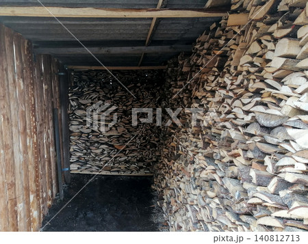 firewood warehouse under a shed filled with chopped neatly stacked logs 140812713