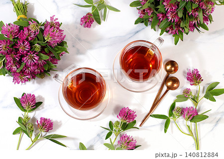 Red clover infusion in glasses with a bouquet of flowers, medicinal herbal tea, alternative folk medicine concept, green pharmacy advertisement, a collection of beneficial herbs for folk medicine, Red clover infusion in glasses with a bouquet of flowers, medicinal herbal tea, alternative folk medicine concept, green pharmacy advertisement, a collection of beneficial herbs for folk medicine, 140812884