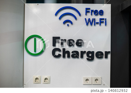 Free wi-fi and charger sign on wall Free wi-fi and charger sign on wall 140812932