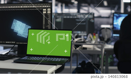 Computer scientist programs on a green screen computer in a data center with generative AI assistance. 140813068