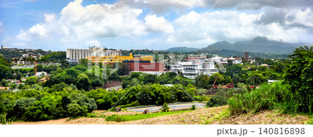 Panoramic scenic view of Pierre Zobda-Quitman University Hospital within the lush tropical landscape buildings in La Meynard, Fort-de-France, Martinique, with green mountains in the background under a 140816898