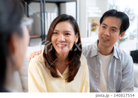 Asian couple in living room consulting with psychologist for marriage therapy mental health. Asian couple in living room consulting with psychologist for marriage therapy mental health. 140817554
