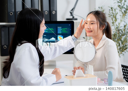 Doctor touching face of patient in clinic and discussing skin analysis on computer screen with ai. Doctor touching face of patient in clinic and discussing skin analysis on computer screen with ai. 140817605