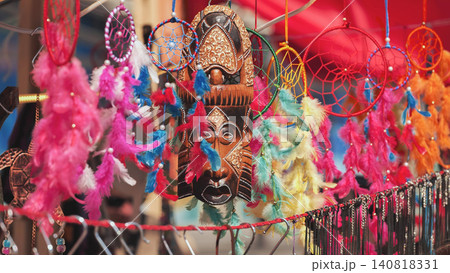 Indian market stall with traditional wood mask and colorful dreamcatchers for sale 140818331