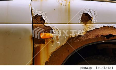 Car body corroding in Moscow, showing extensive rust damage and paint peeling 140818484