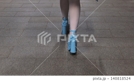 Woman walking on pavement with light blue high heel shoes and white stockings Woman walking on pavement with light blue high heel shoes and white stockings 140818524