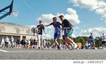 Asphalt basketball court with blurred players in action on a sunny day. Asphalt basketball court with blurred players in action on a sunny day. 140818527